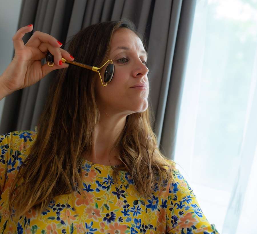 Alma demonstrating use of face roller in her beauty salon