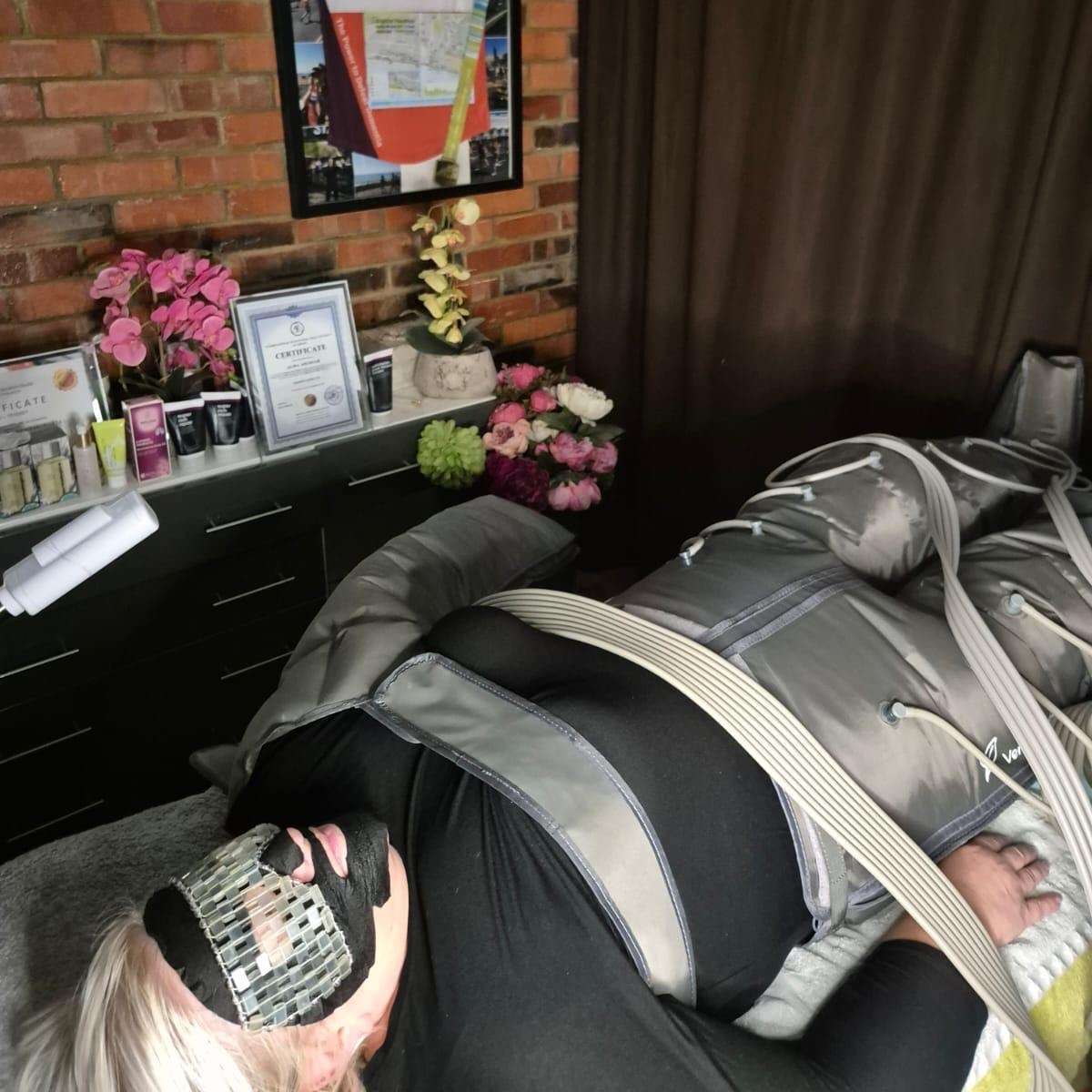 woman lay inside lymphatic drainage machine